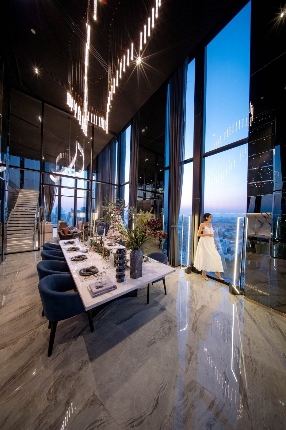 Park Origin Phayathai — dining lounge with a long marble table and city views