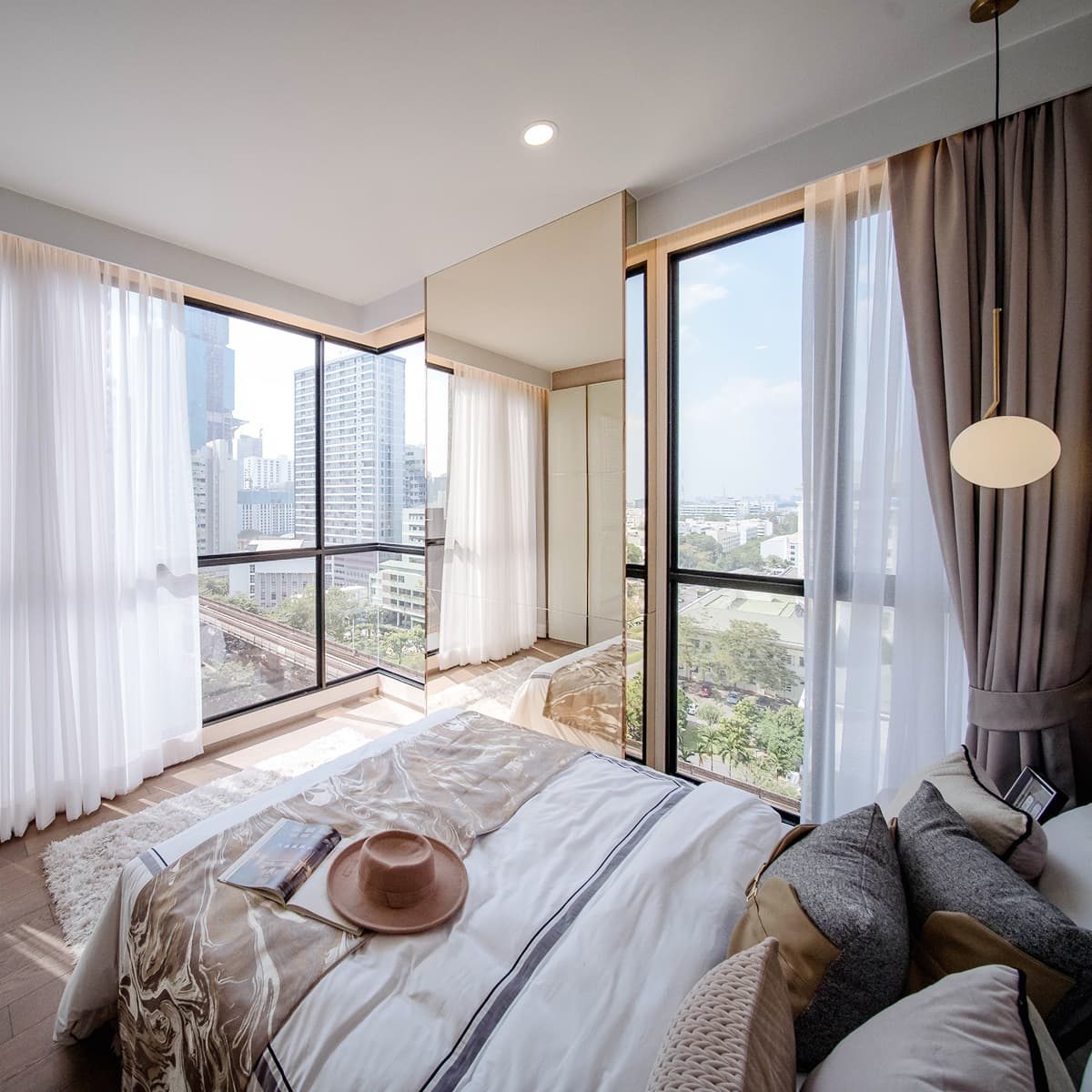 Park Origin Phayathai — bright bedroom with floor-to-ceiling windows